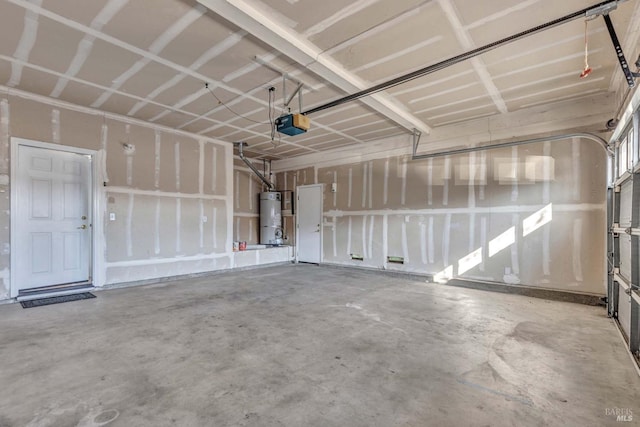 garage with a garage door opener and water heater