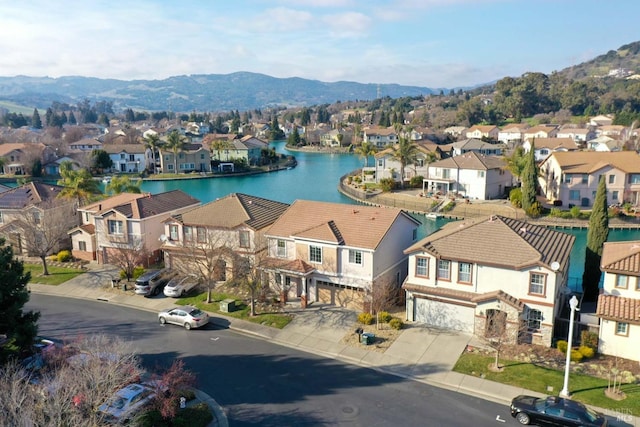 bird's eye view with a water and mountain view