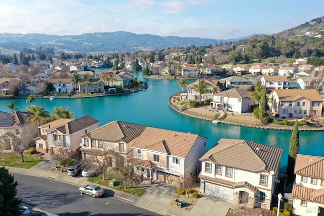 aerial view featuring a water and mountain view