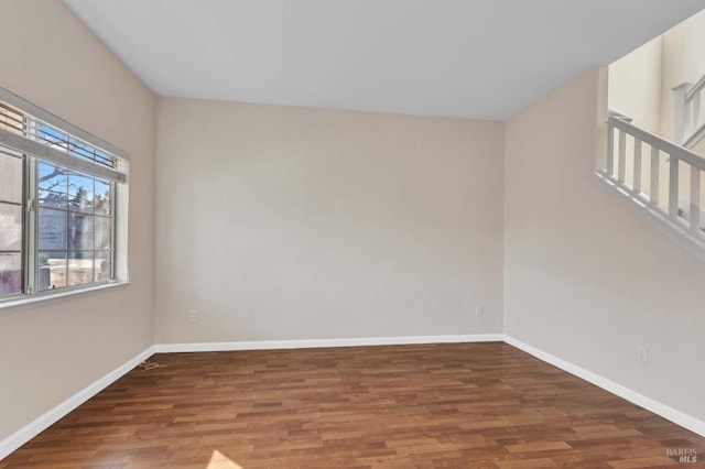 spare room with dark hardwood / wood-style flooring