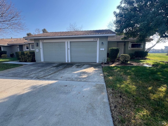 view of front of home featuring a garage and a front yard