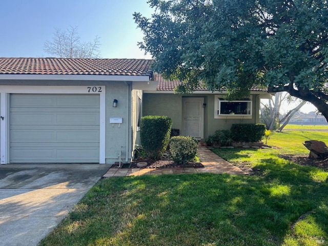 view of front of home with a garage and a front yard