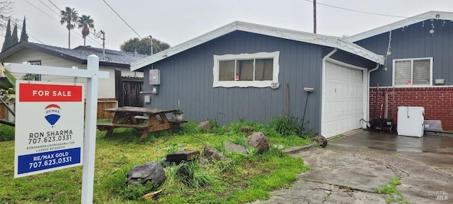 view of side of home featuring a garage