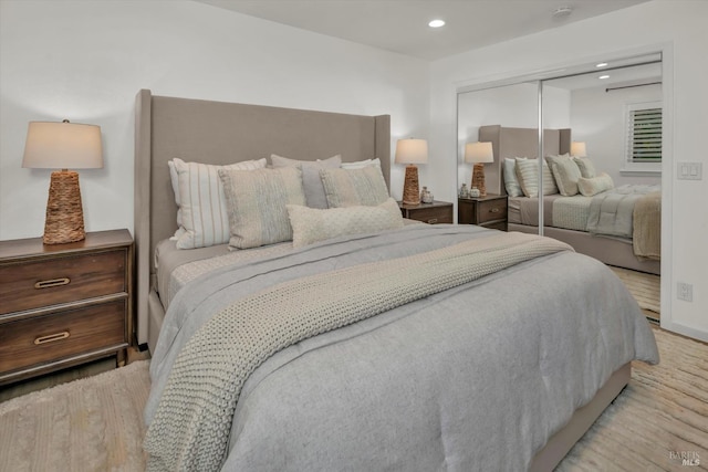 bedroom with light hardwood / wood-style flooring and a closet