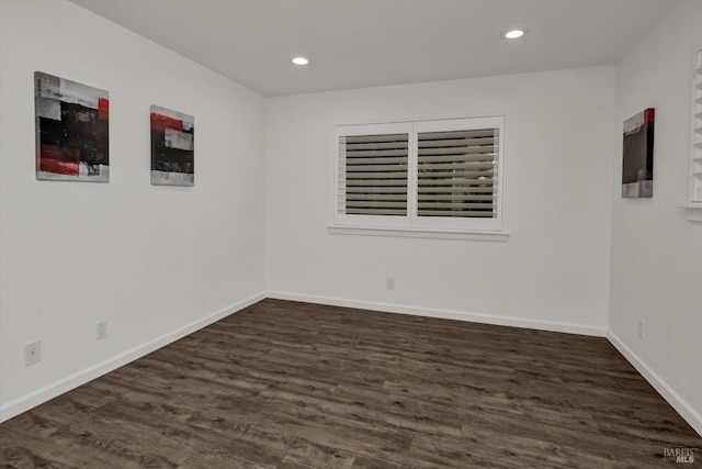 spare room featuring dark wood-type flooring