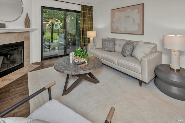 living room featuring wood-type flooring and a high end fireplace