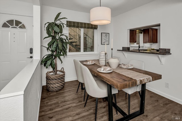 dining area featuring dark wood-type flooring