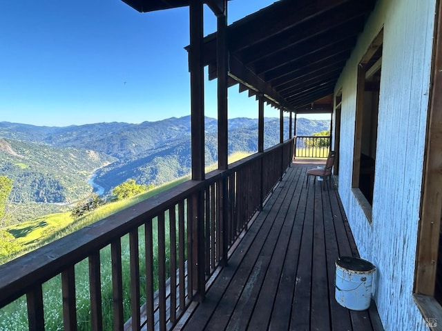 wooden deck featuring a mountain view