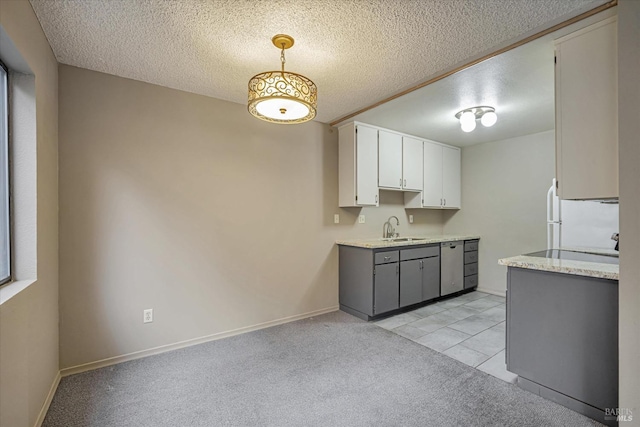 kitchen with light carpet, a sink, a textured ceiling, freestanding refrigerator, and white cabinets