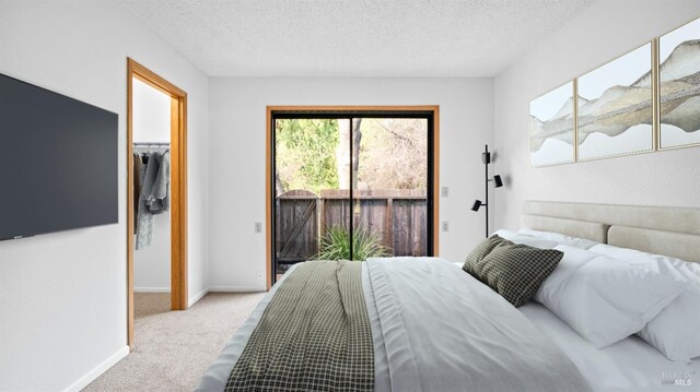 unfurnished bedroom featuring a closet, baseboards, a textured ceiling, and carpet flooring