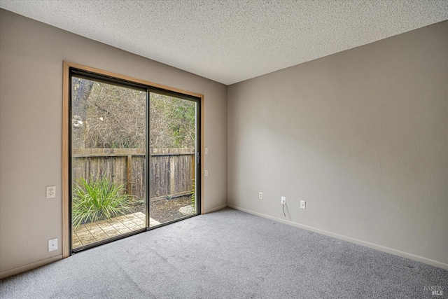 unfurnished room with baseboards, a textured ceiling, and carpet flooring