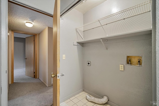 laundry room featuring electric dryer hookup, light carpet, a textured ceiling, hookup for a washing machine, and laundry area