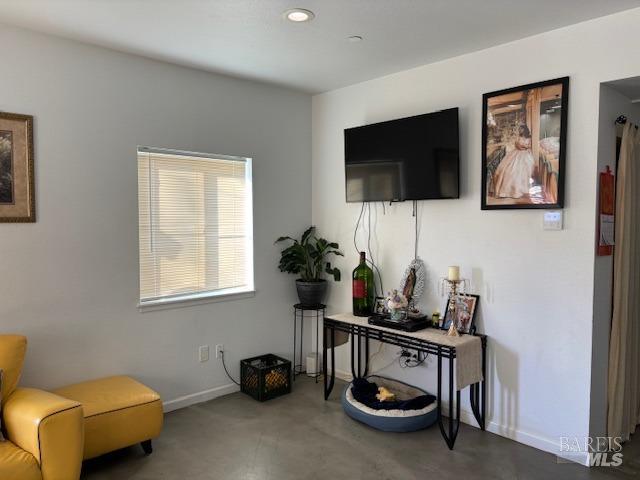 living room featuring concrete flooring