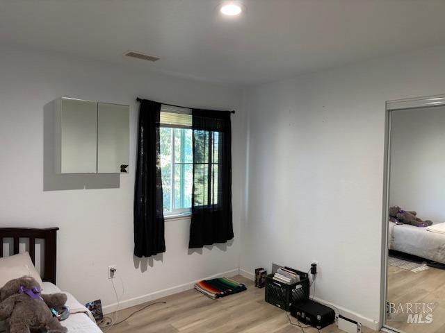 bedroom with light hardwood / wood-style flooring