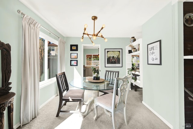 carpeted dining room with an inviting chandelier