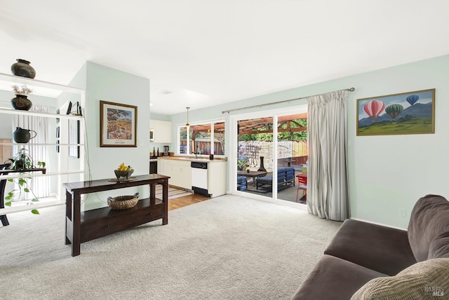 living room with light carpet and sink