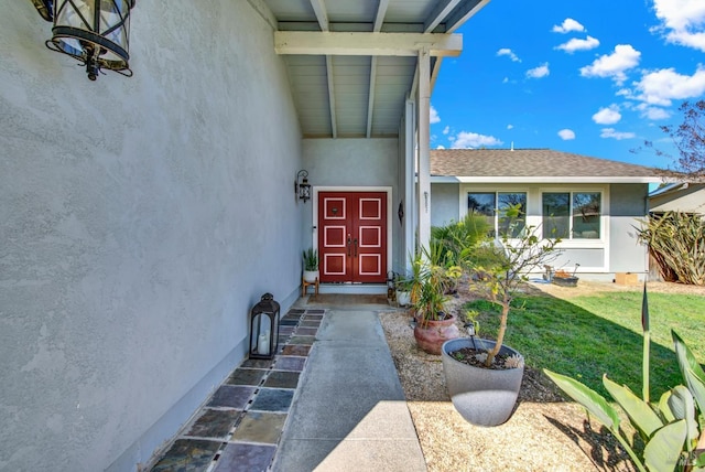 doorway to property featuring a yard