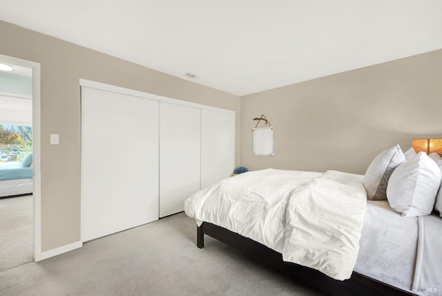 carpeted bedroom featuring a closet