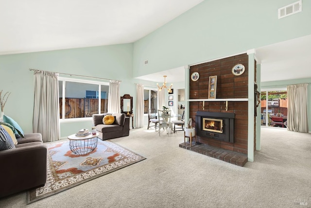 carpeted living room with high vaulted ceiling, a chandelier, and a fireplace