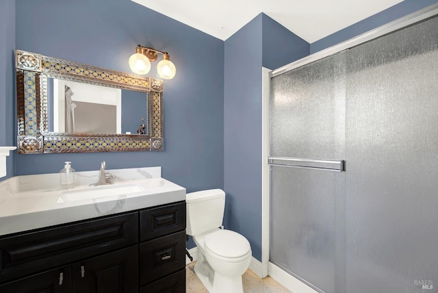 bathroom with vanity, an enclosed shower, and toilet