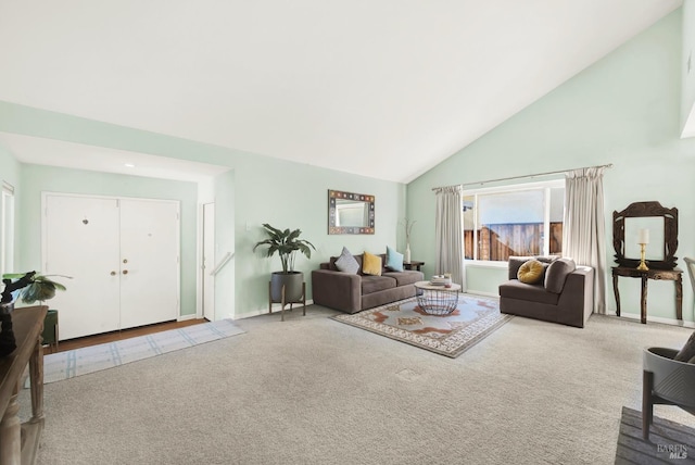 living room featuring light colored carpet and high vaulted ceiling