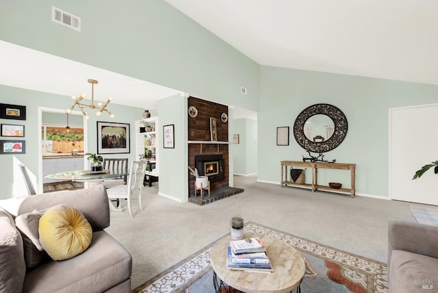 carpeted living room featuring an inviting chandelier and high vaulted ceiling