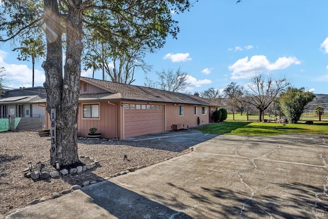 exterior space featuring a garage and a front lawn