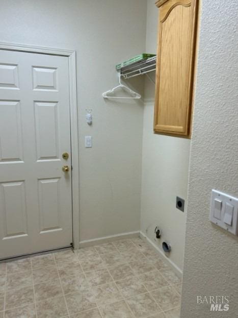 laundry room featuring cabinets and hookup for an electric dryer