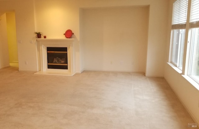 unfurnished living room with light carpet