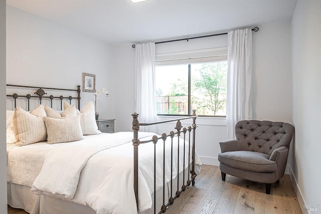 bedroom with hardwood / wood-style flooring