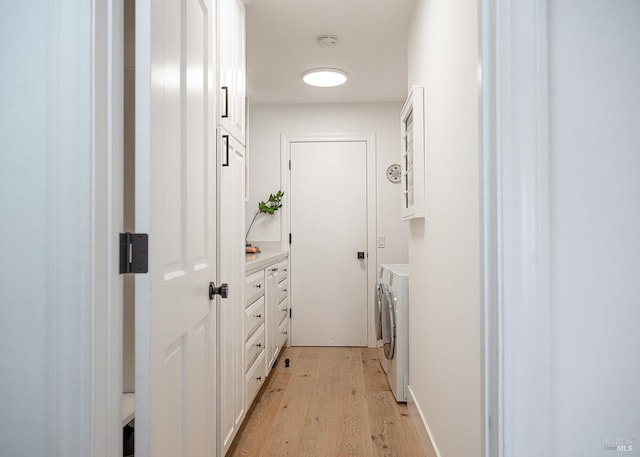 interior space featuring independent washer and dryer and light hardwood / wood-style flooring