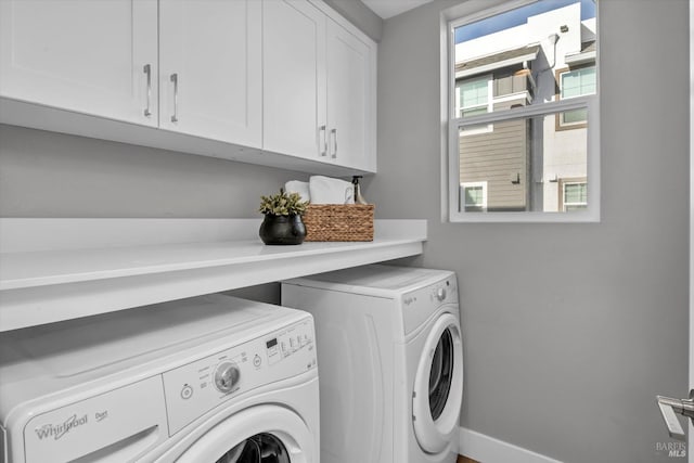 laundry area featuring cabinets and washing machine and dryer