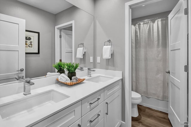 full bathroom with hardwood / wood-style flooring, vanity, toilet, and shower / bath combination with curtain