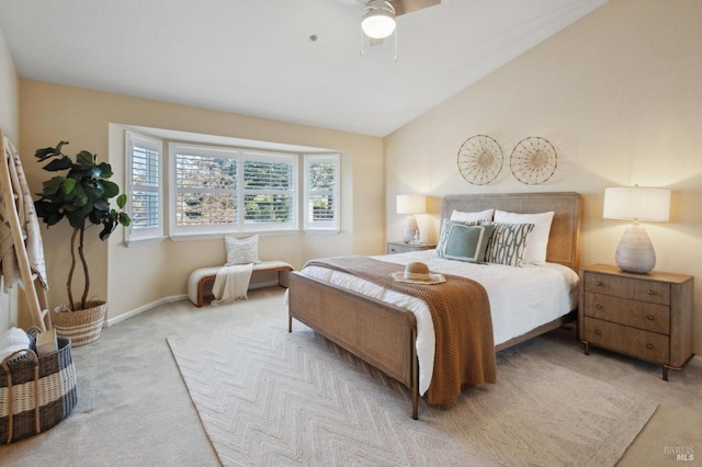 carpeted bedroom with ceiling fan and vaulted ceiling