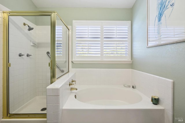 bathroom featuring shower with separate bathtub