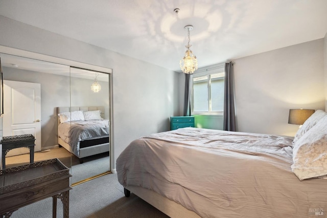 carpeted bedroom featuring an inviting chandelier and a closet