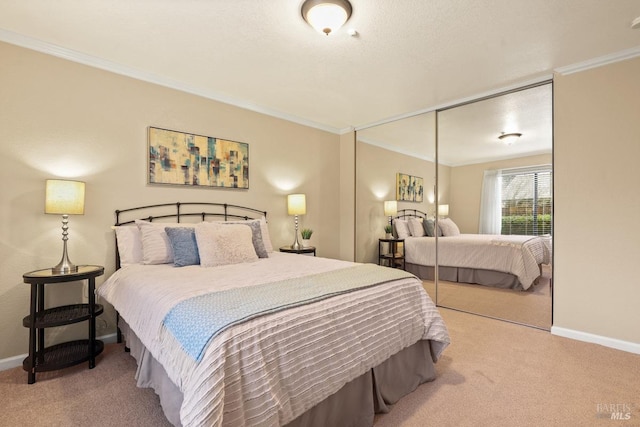 carpeted bedroom featuring ornamental molding and a closet