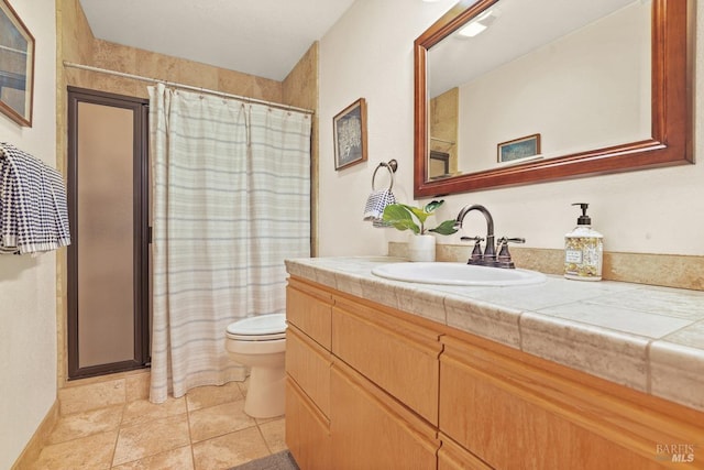 bathroom featuring tile patterned floors, toilet, and vanity