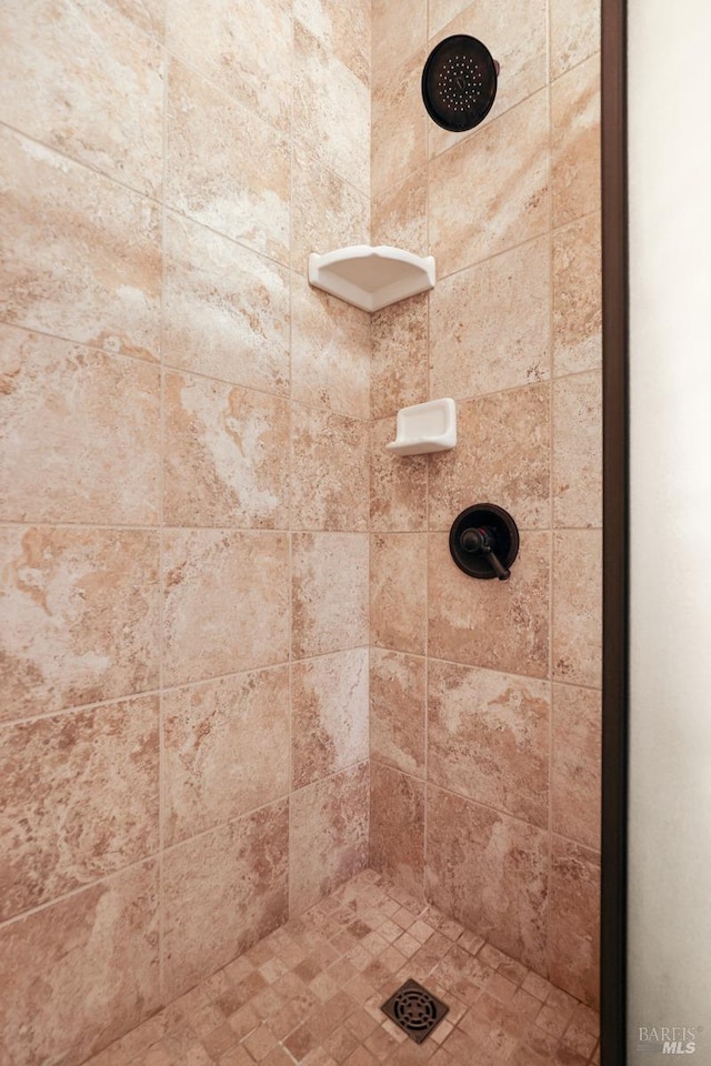 bathroom with tiled shower