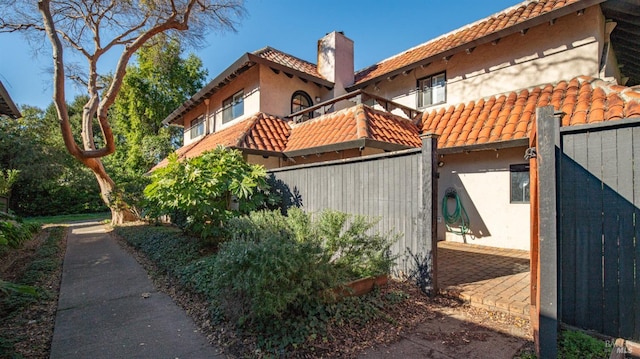 view of side of home with a balcony