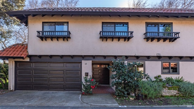 mediterranean / spanish-style house with a garage