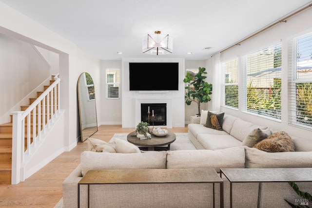 living room featuring a chandelier and light hardwood / wood-style flooring