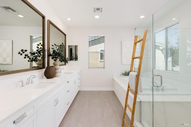 bathroom featuring vanity and independent shower and bath