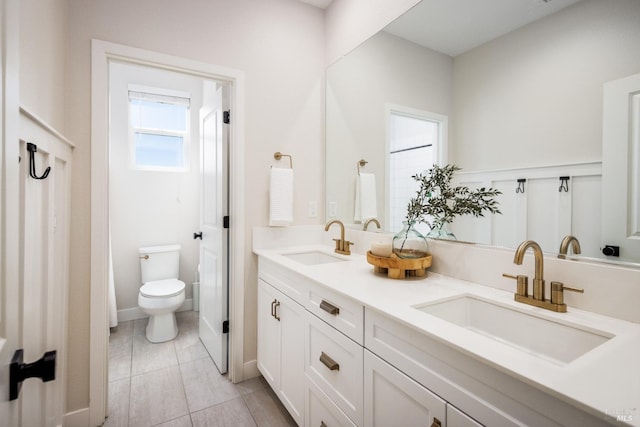 bathroom featuring vanity, tile patterned floors, and toilet