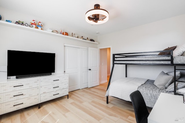 bedroom with a closet and light hardwood / wood-style flooring