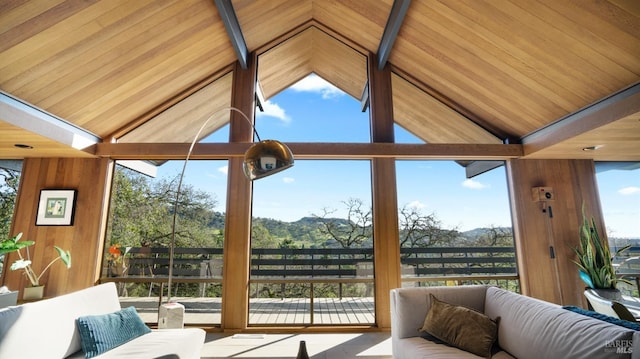 sunroom featuring vaulted ceiling with beams