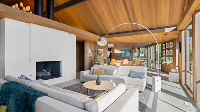 living room featuring light tile patterned floors, wooden walls, a fireplace, vaulted ceiling, and wooden ceiling