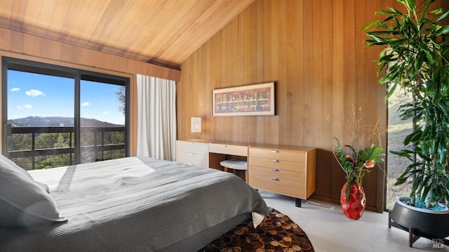 bedroom featuring vaulted ceiling, a mountain view, and wooden walls