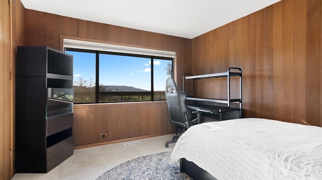 bedroom with a mountain view and wood walls