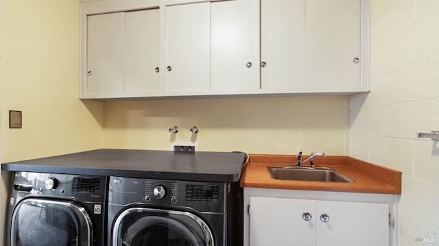 washroom featuring independent washer and dryer, cabinets, and sink